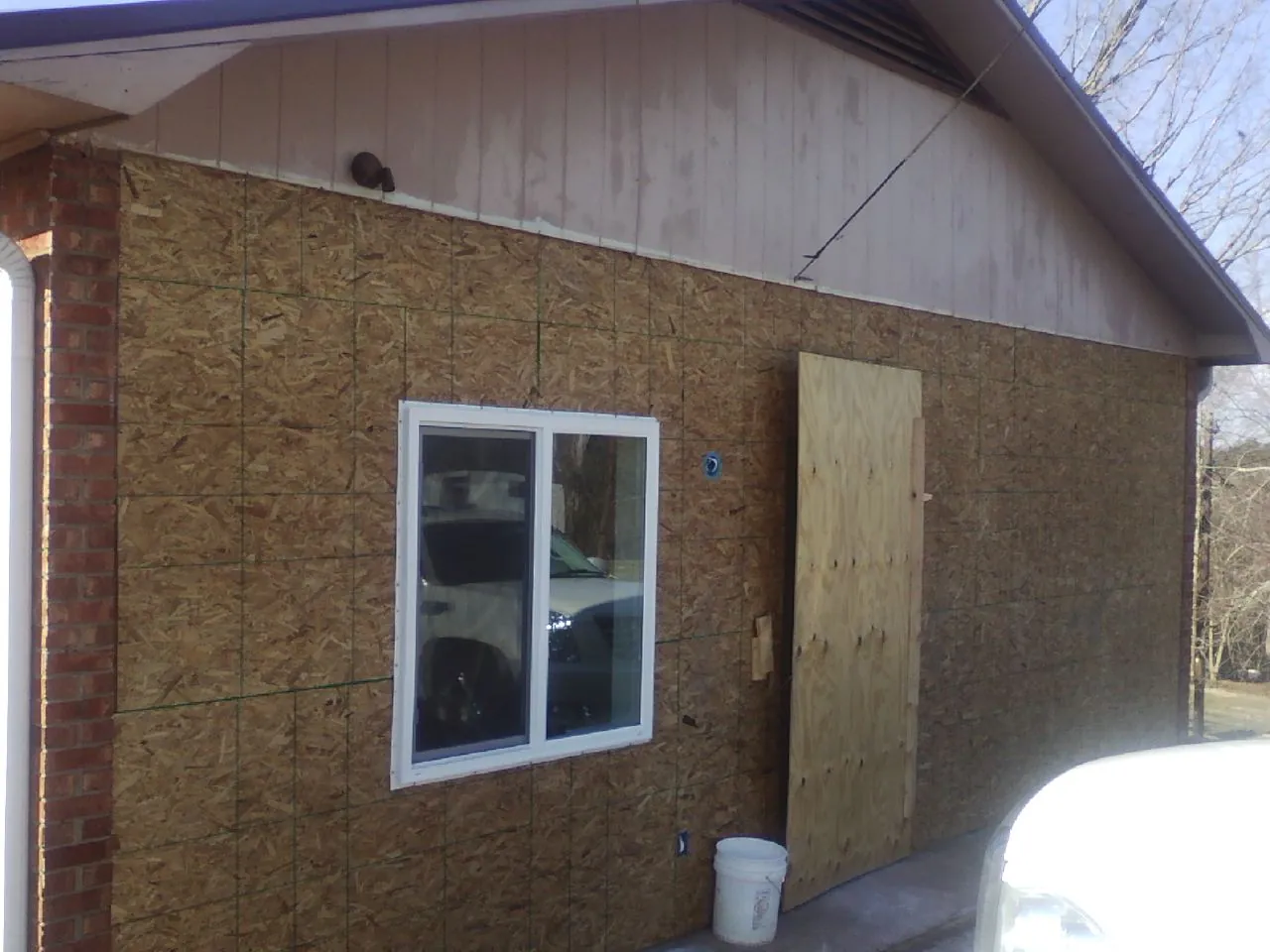 OSB sheathing on a garage addition wall before siding in White Plains
